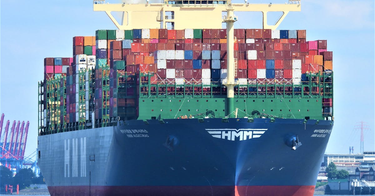 Front view of a massive cargo ship loaded with containers in Hamburg's harbor.